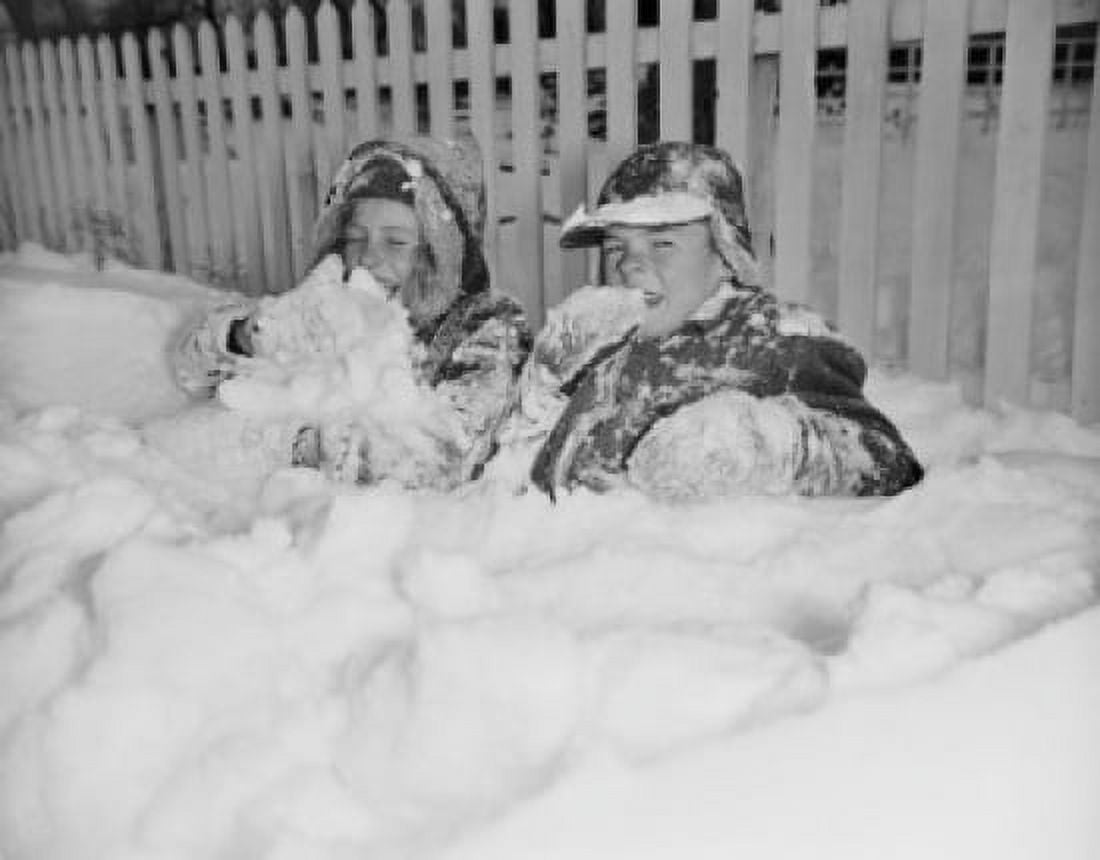 Two boys playing in snow Canvas Art - (24 x 36)