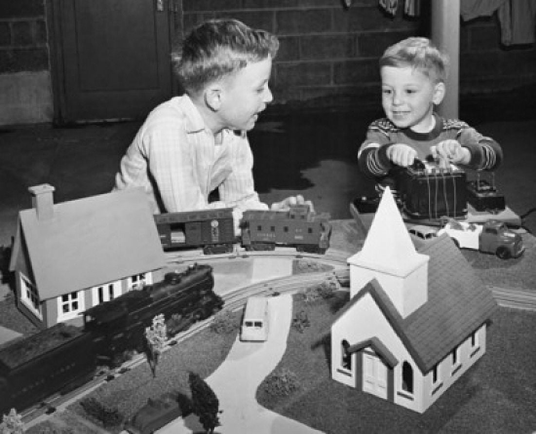 Two boys playing with a train set Canvas Art - (24 x 36)
