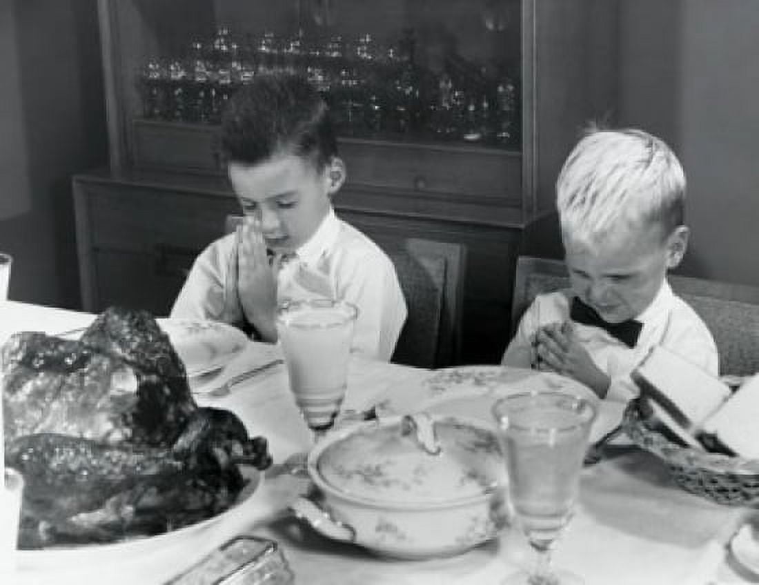 Two boys praying at a dining table on Thanksgiving Day Canvas Art - (24 x 36)