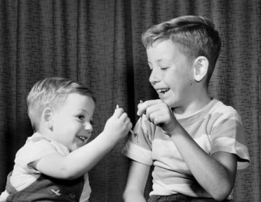 Two boys pulling a wishbone and smiling Canvas Art - (18 x 24)