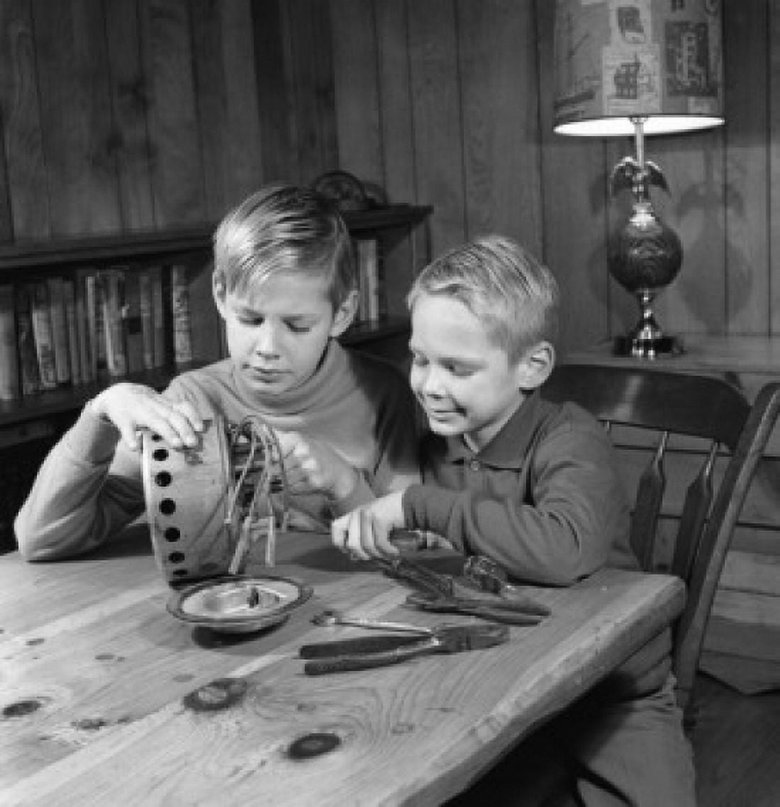 Two boys repairing machine Canvas Art - (18 x 24)