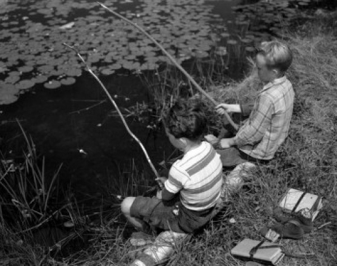 Two boys sitting and fishing with homemade fishing rod Canvas Art - (24 x 36)