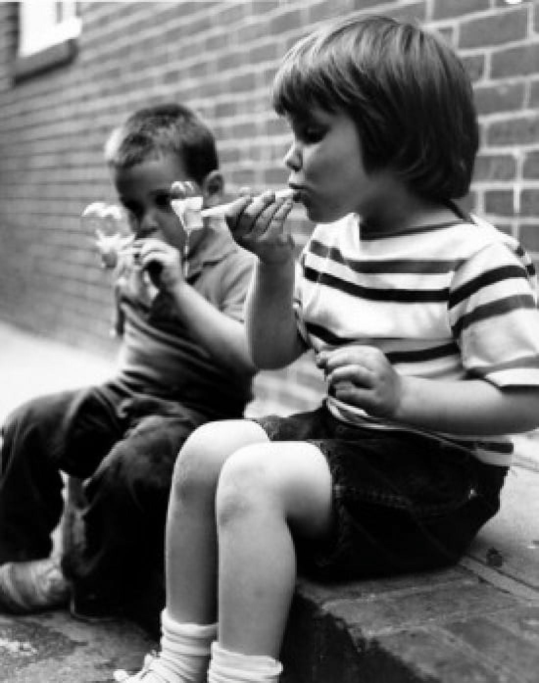 Two boys sitting on curb blowing bubbles Canvas Art - (18 x 24)