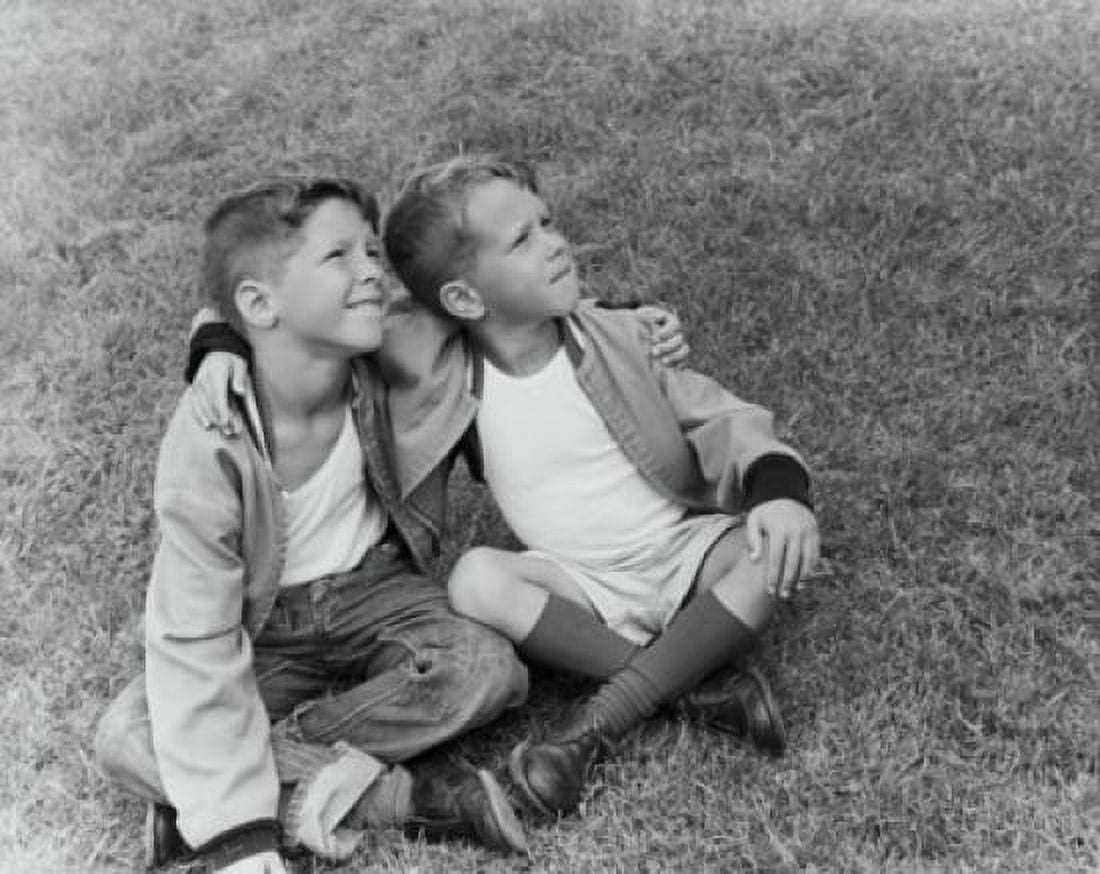 Two boys sitting on the grass with their arms around each other Canvas Art - (18 x 24)