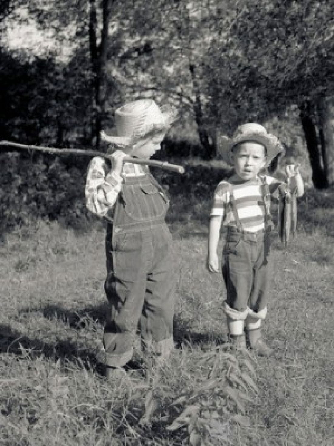 Two boys with bunch of fish and fishing rod made of stick in field Canvas Art - (18 x 24)