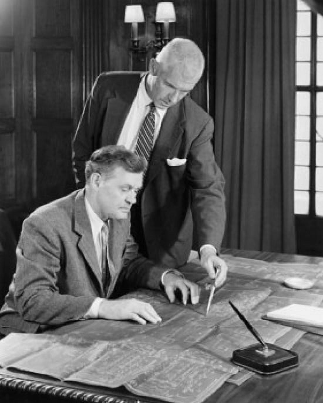 Two businessmen discussing blueprint in office Canvas Art - (18 x 24)