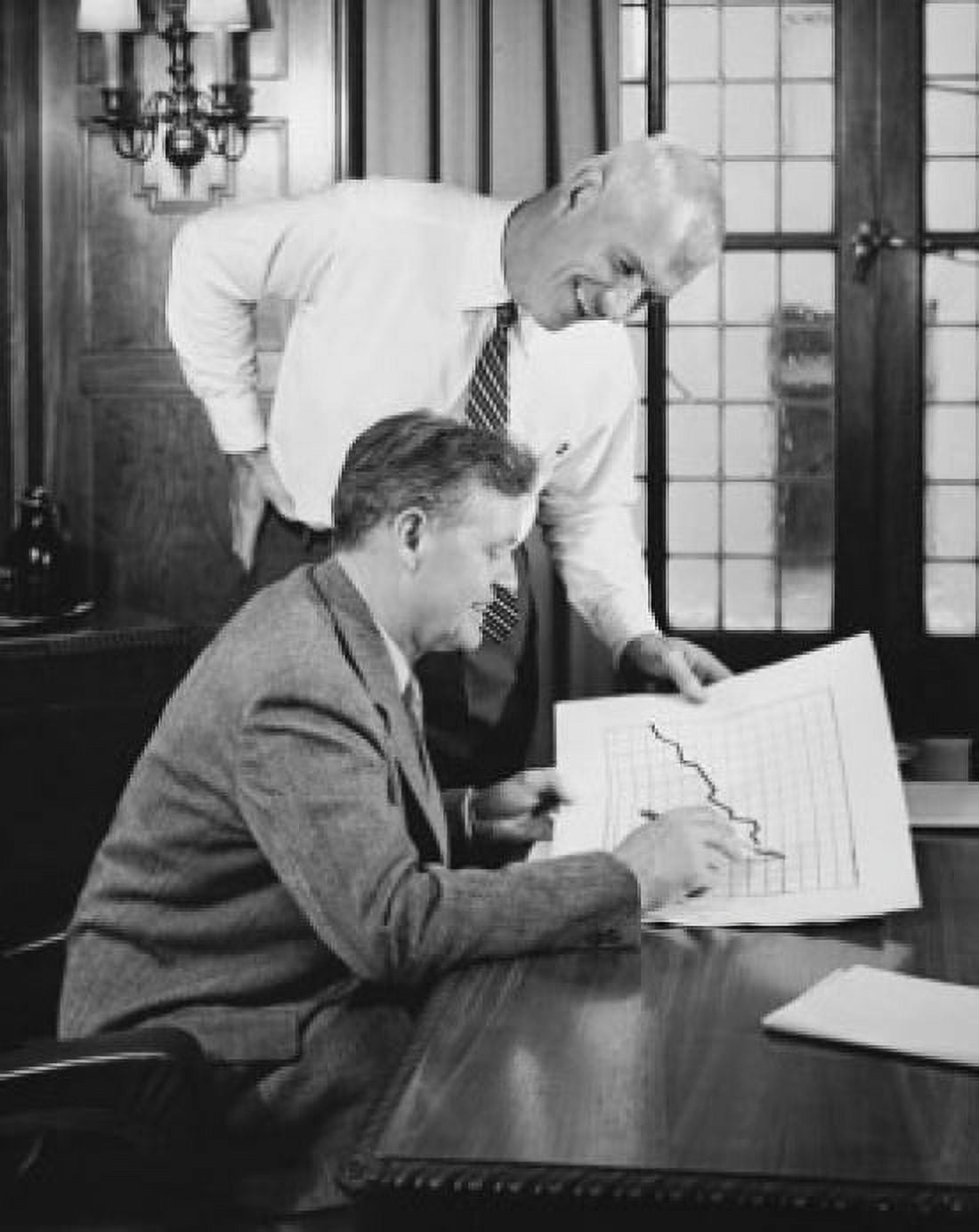Two businessmen looking at a line graph and smiling Canvas Art - (24 x 36)