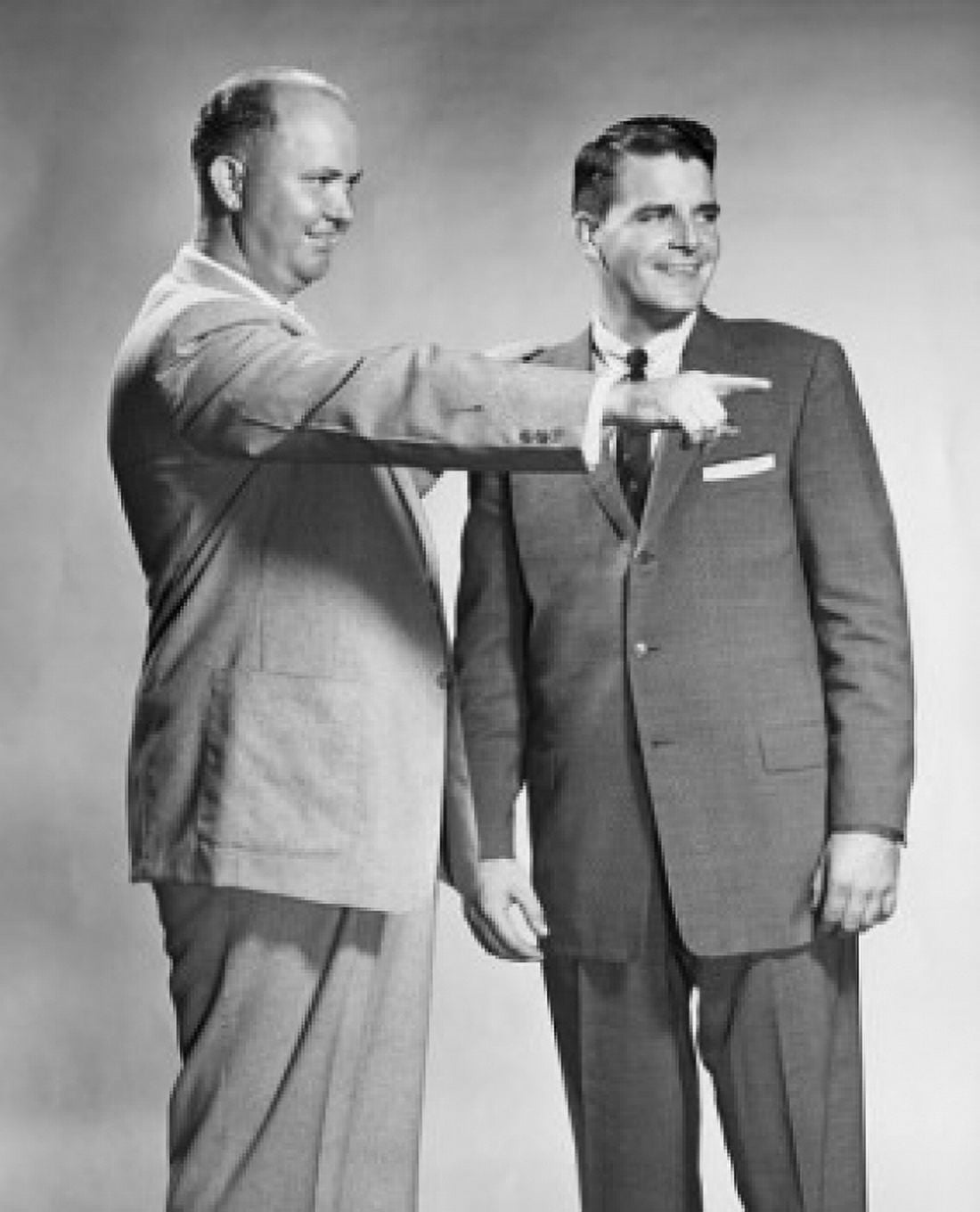 Two businessmen standing together one pointing Canvas Art - (18 x 24)