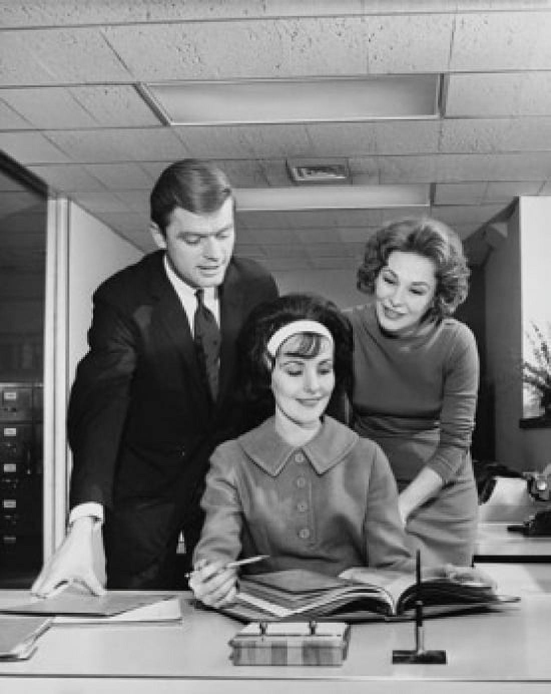 Two businesswomen and a businessman looking at a file in an office Canvas Art - (24 x 36)