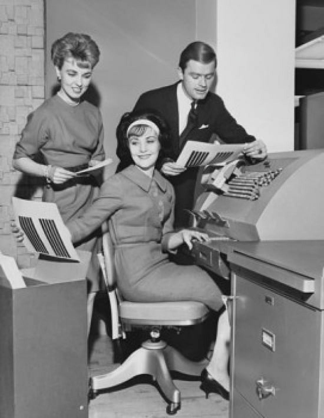 Two businesswomen and a businessman working on an accounting machine Canvas Art - (18 x 24)