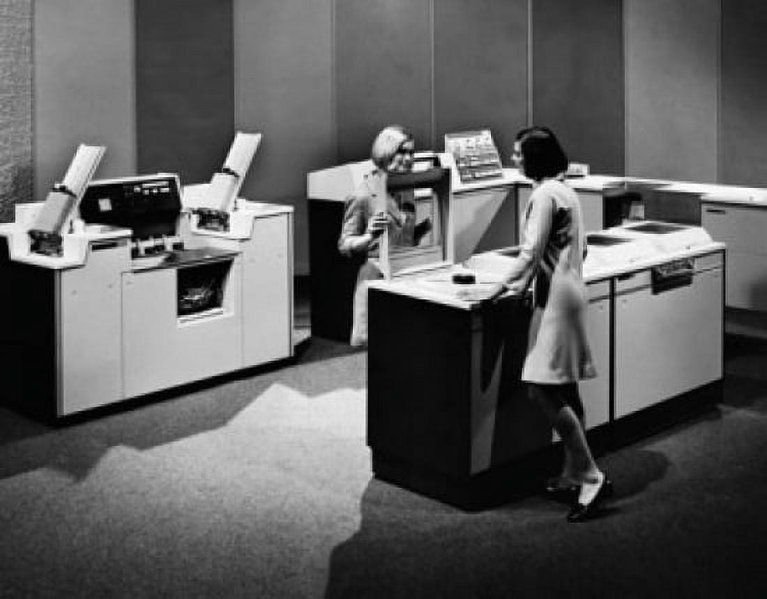 Two businesswomen standing near a mainframe computer Canvas Art - (18 x 24)