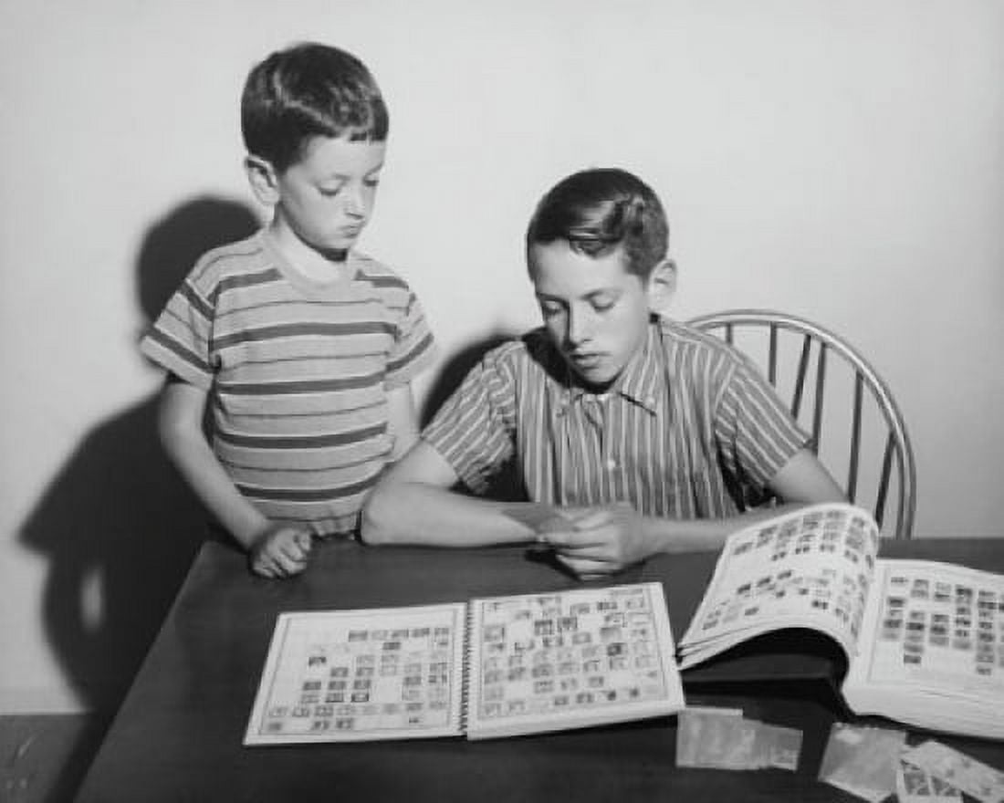 Two children looking at a collection of postage stamps Canvas Art -  (24 x 36)