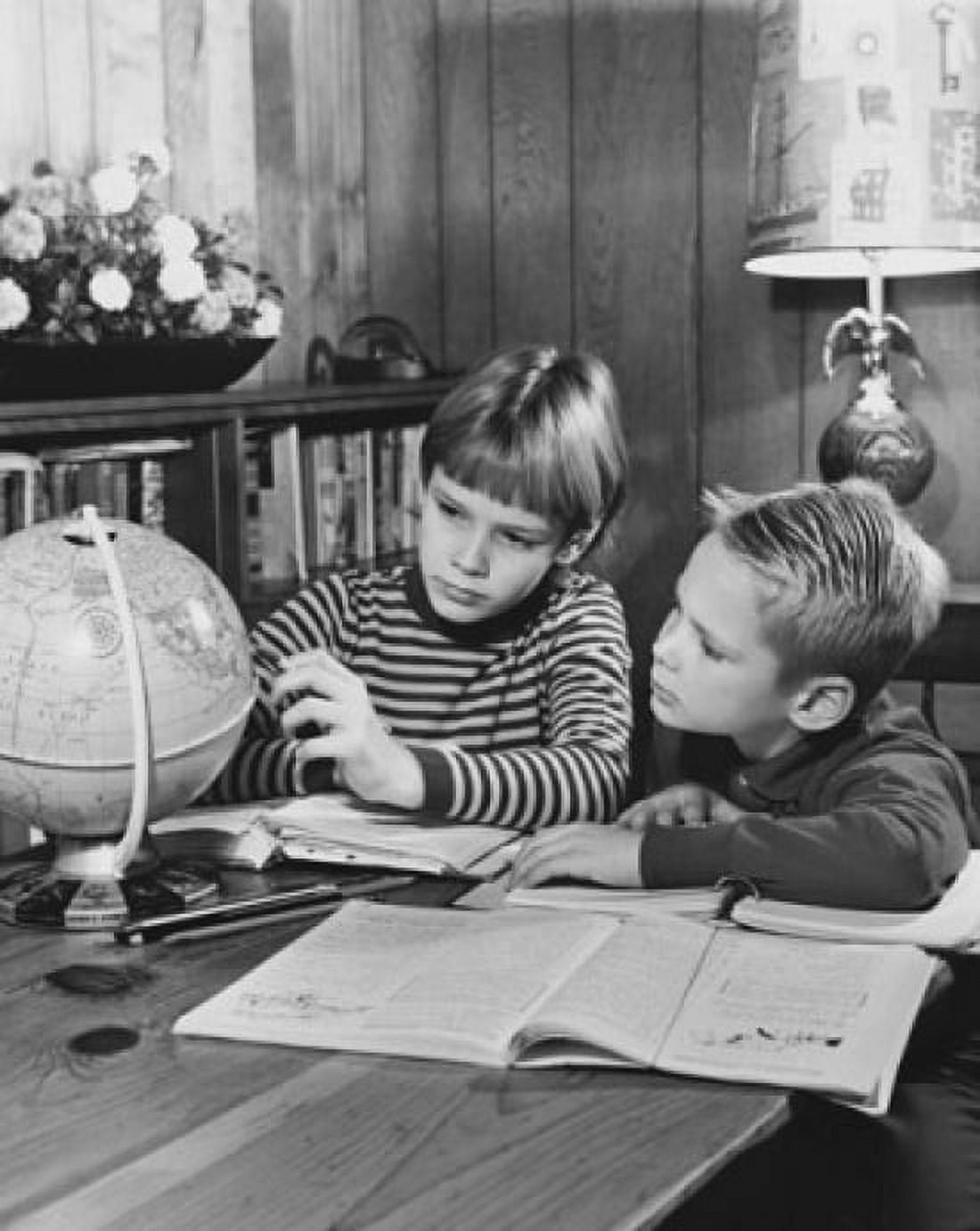 Two children sitting and looking at a globe Canvas Art - (24 x 36)