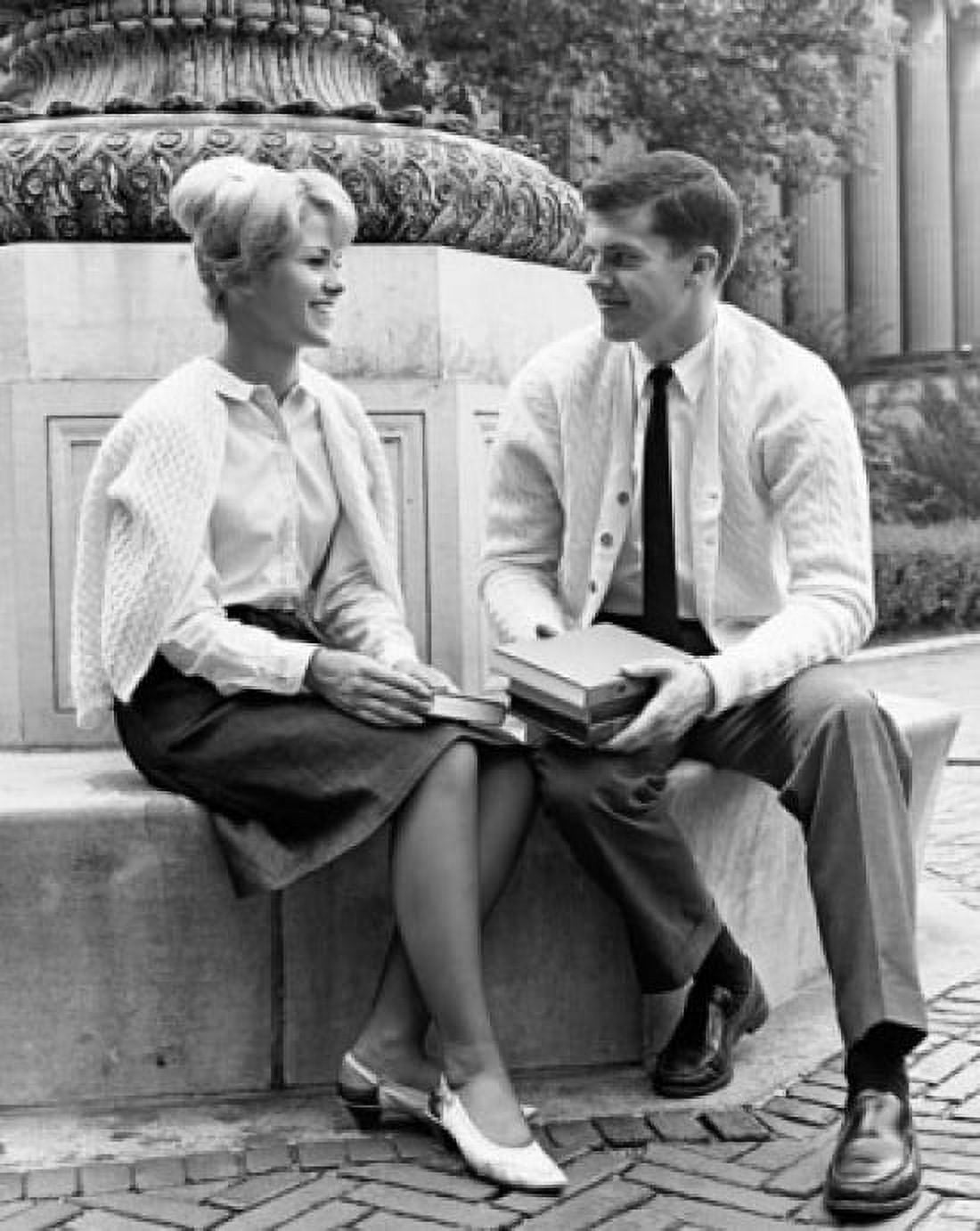 Two college students sitting on a ledge and smiling Canvas Art - (18 x 24)