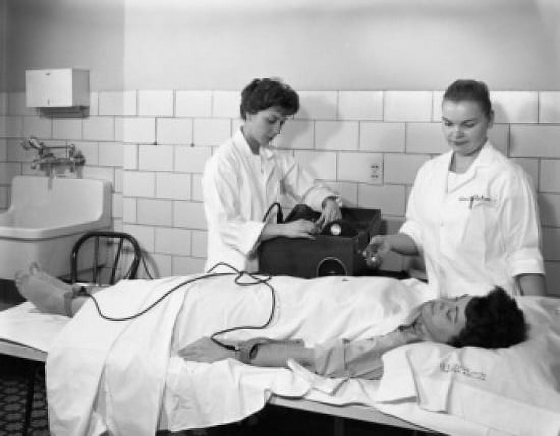 Two female doctors examining woman Canvas Art - (18 x 24)