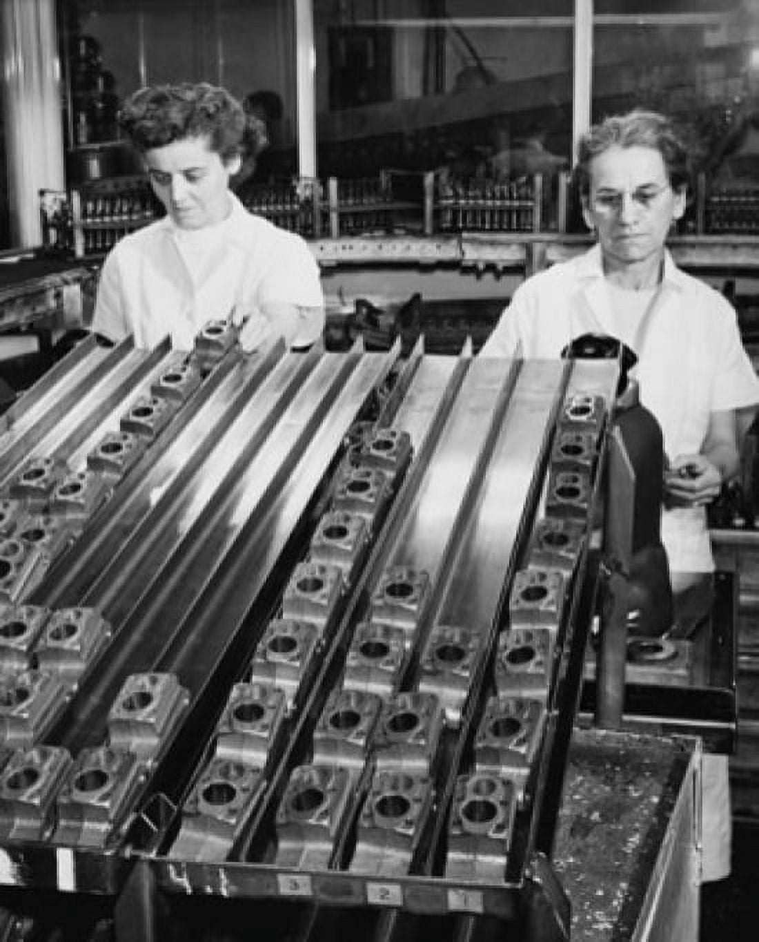 Two female workers using air gauge to sort cylinders used in a household refrigerator compressor Canvas Art - (24 x 36)