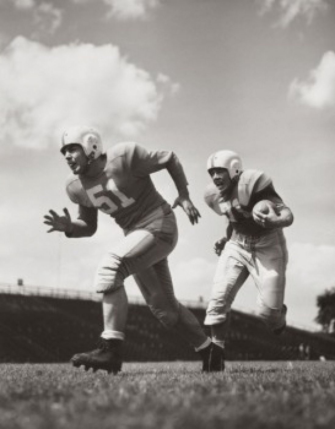 Two football players running with a football on a football field Canvas Art -  (18 x 24)