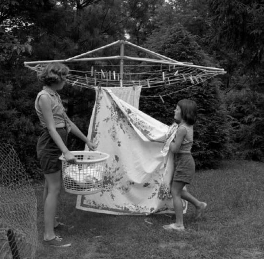 Two girls doing laundry in garden Canvas Art - (18 x 24)