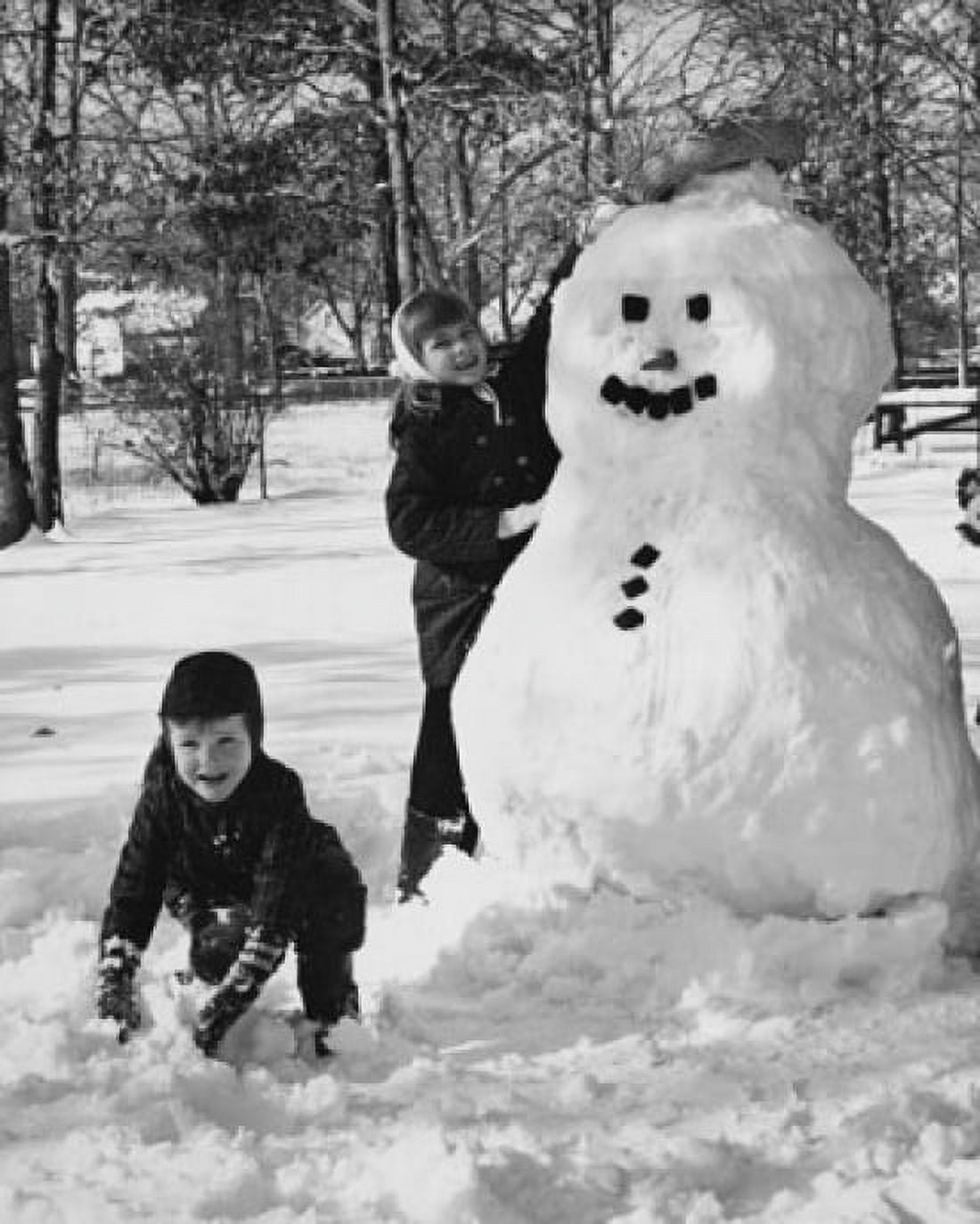 Two girls making a snowman Canvas Art - (18 x 24)