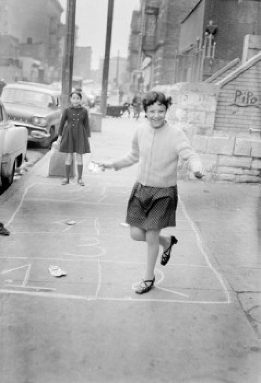 Two girls playing hop-scotch on street Canvas Art - (18 x 24)