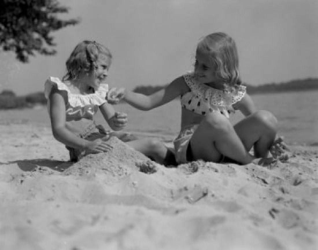 Two girls playing in sand on beach Canvas Art - (24 x 36)