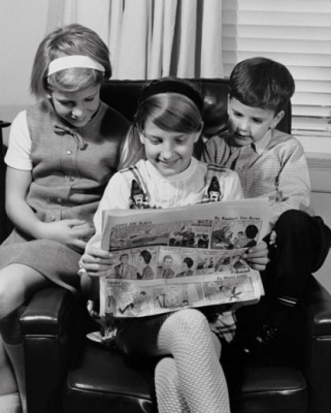 Two girls with their brother sitting in an armchair and reading a newspaper Canvas Art - (18 x 24)
