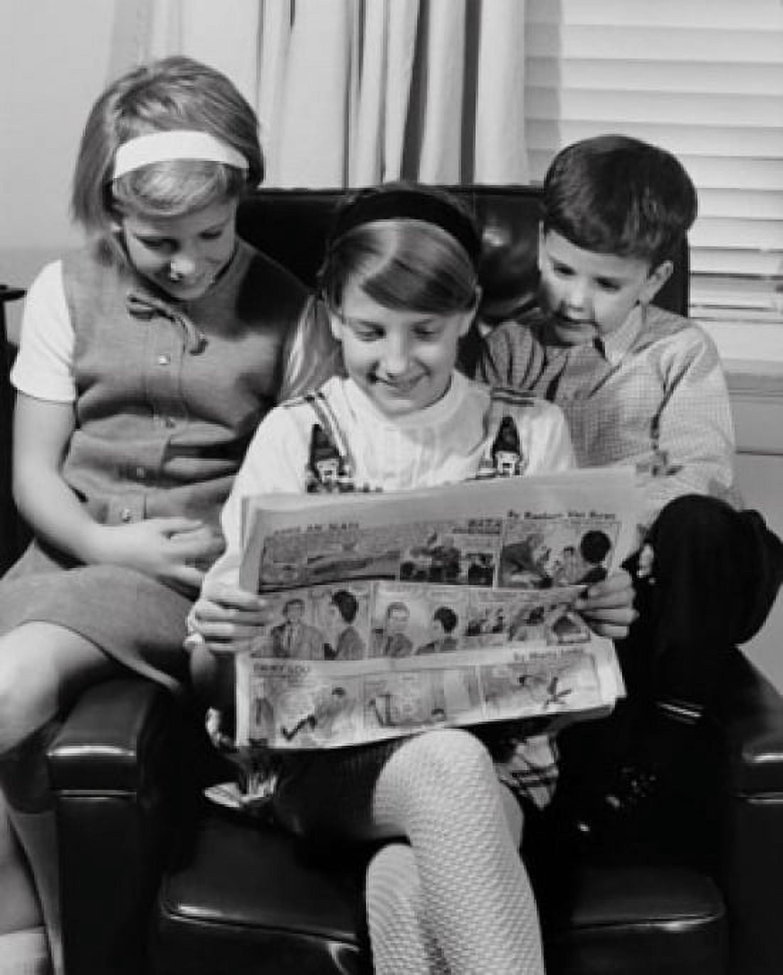 Two girls with their brother sitting in an armchair and reading a newspaper Canvas Art - (24 x 36)