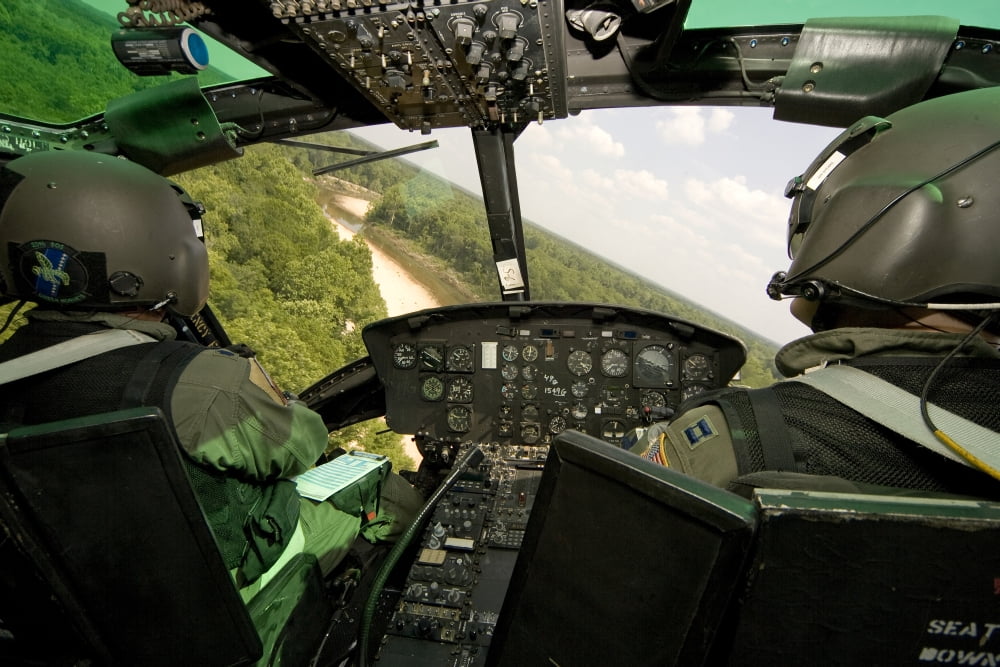 Two instructor pilots practice low flying operations in a UH-1H Huey helicopter Canvas Art - Erik RoelofsStocktrek Images (35 x 23)