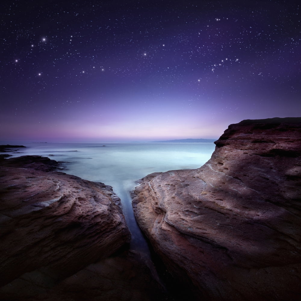 Two large rocks in a sea against starry sky Canvas Art - Evgeny KuklevStocktrek Images (29 x 29)