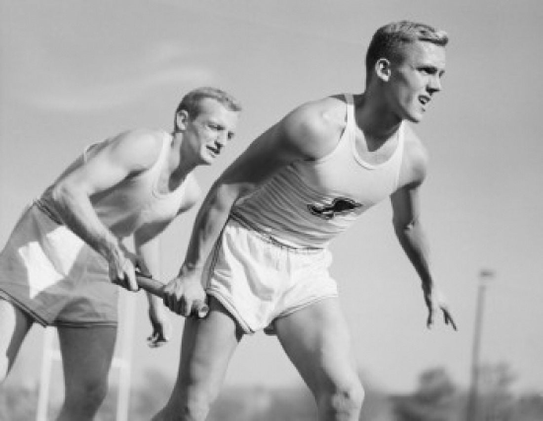 Two men running on relay Canvas Art - (18 x 24)