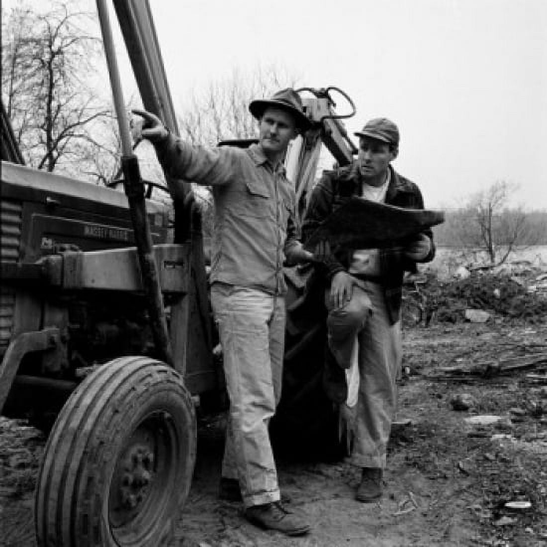 Two men standing by tractor discussing plans Canvas Art - (24 x 36)