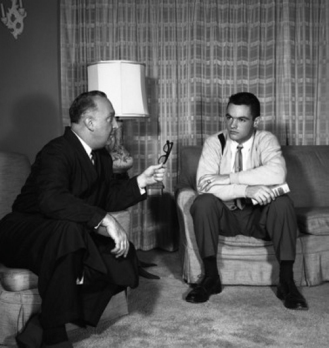Two men talking in living room Canvas Art - (24 x 36)