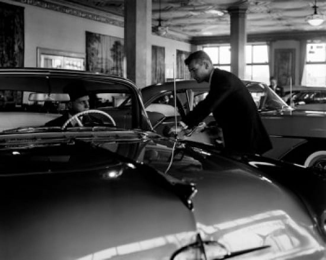 Two mid adult men watching car in automobile dealer showroom Canvas Art - (18 x 24)