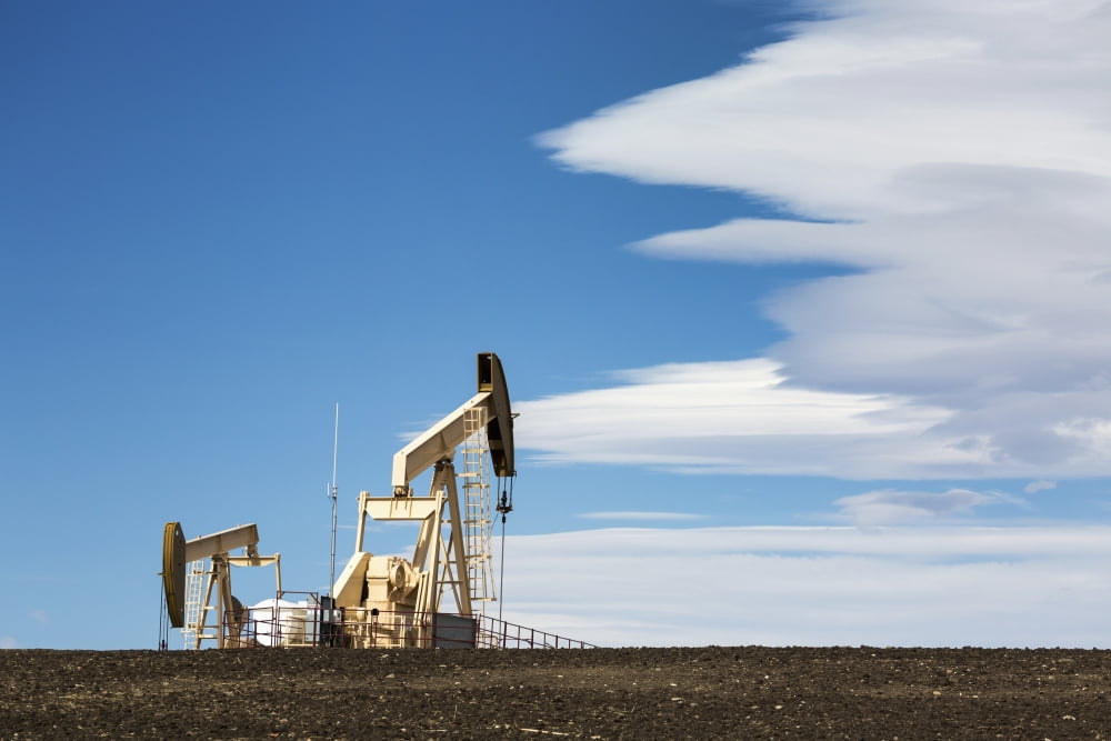 Two pumpjacks on a hill with dramatic clouds in the blue sky Alberta Canada Canvas Art - Michael Interisano Design Pics (19 x 12)