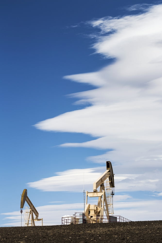 Two pumpjacks on a hill with dramatic clouds in the blue sky Alberta Canada Canvas Art - Michael Interisano Design Pics (24 x 38)