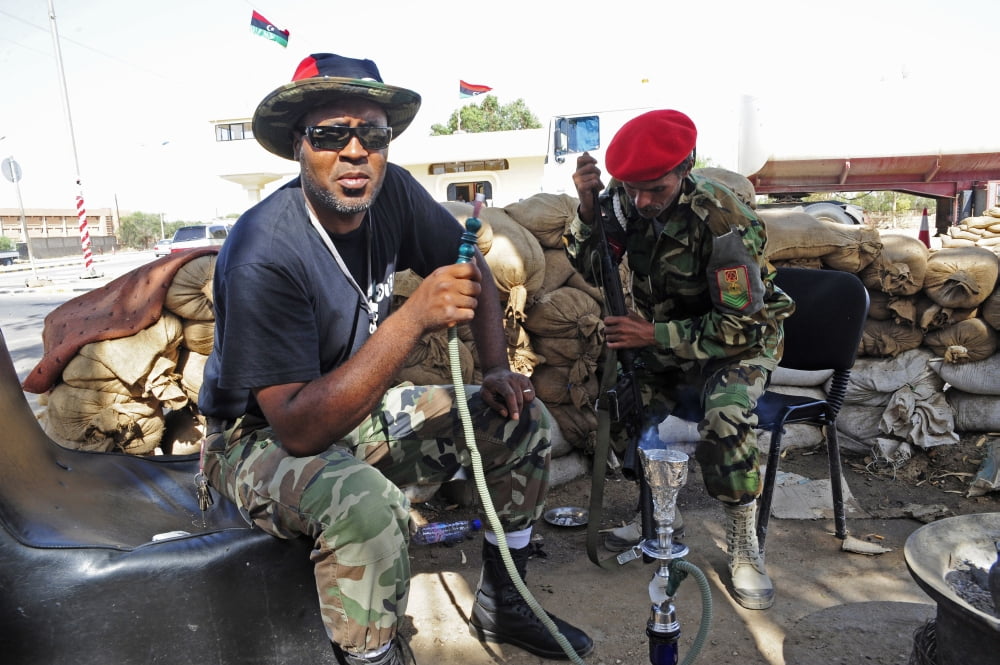 Two rebel fighters man a checkpoint on the outside of Benghazi Libya Canvas Art - Andrew ChittockStocktrek Images (35 x 23)