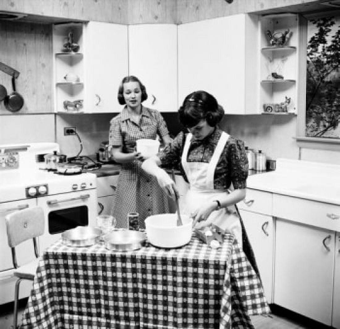 Two teenage girls preparing food in the kitchen Canvas Art - (18 x 24)