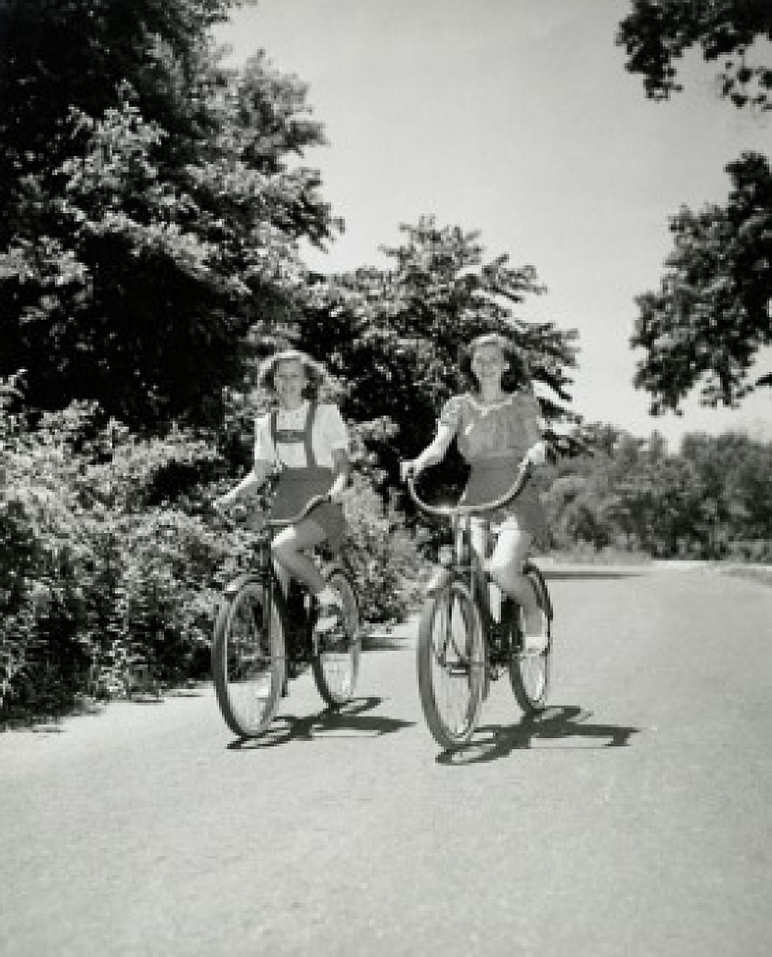 Two teenage girls riding bicycles Canvas Art - (18 x 24)