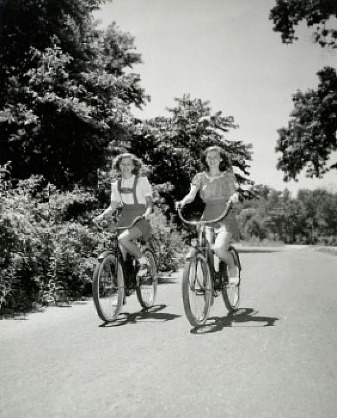 Two teenage girls riding bicycles Canvas Art - (24 x 36)