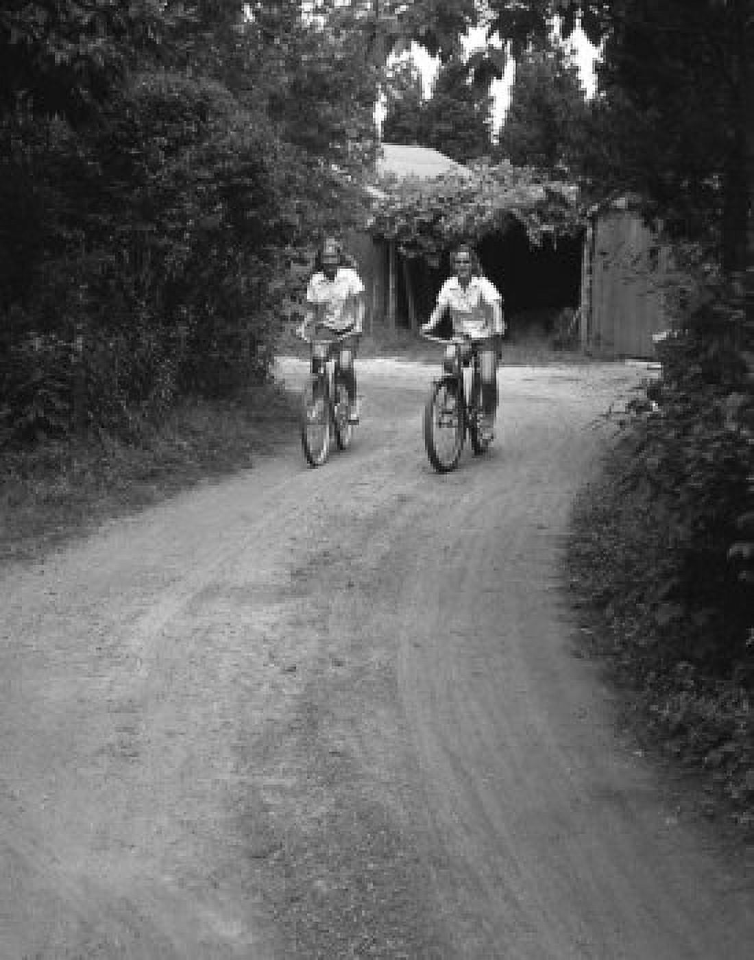 Two teenage girls riding bikes Canvas Art - (24 x 36)