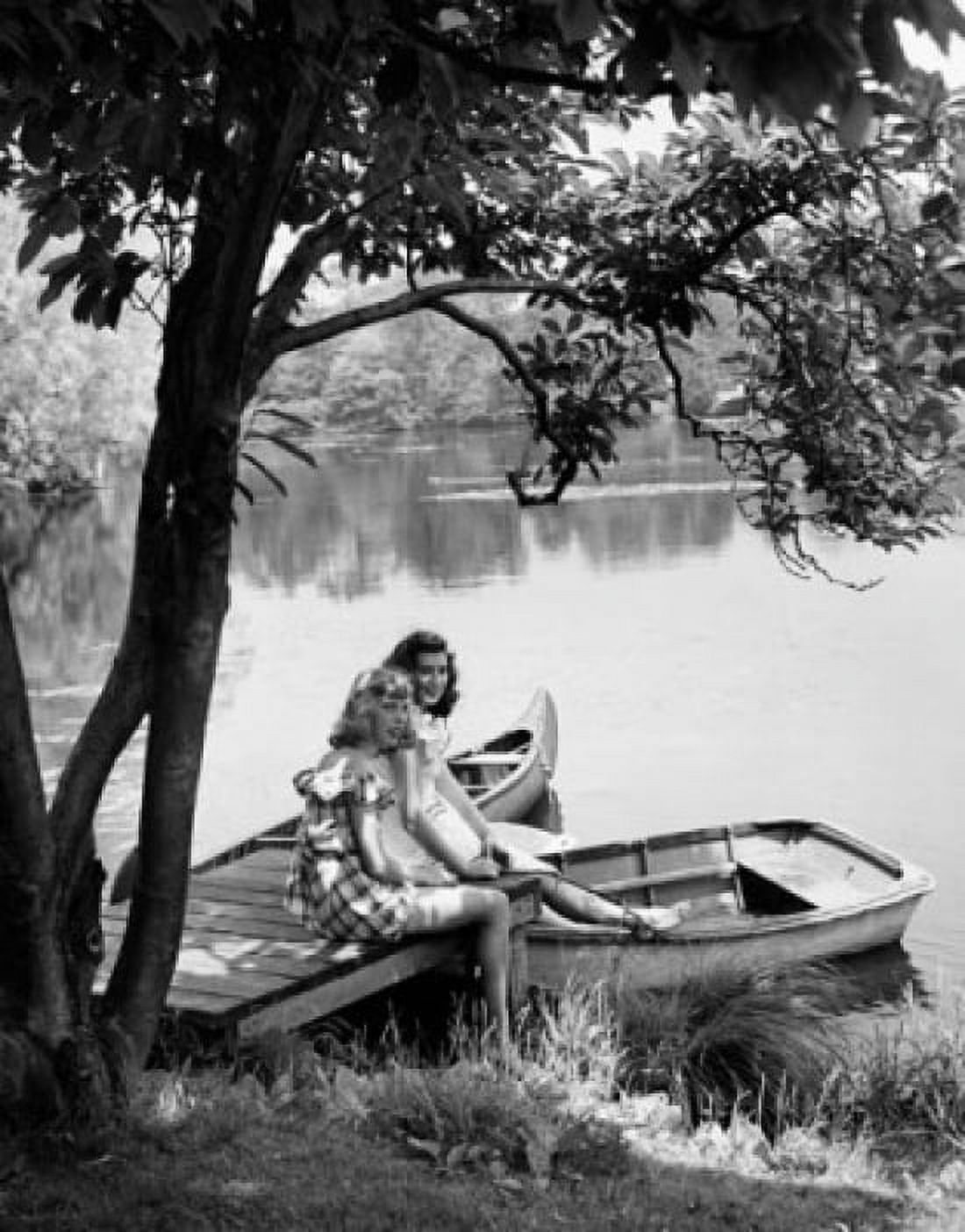 Two teenage girls sitting on a dock Canvas Art - (18 x 24)