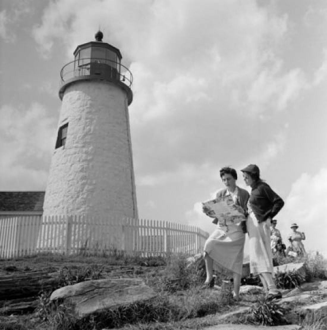 Two woman reading map near lighthouse Canvas Art - (24 x 36)
