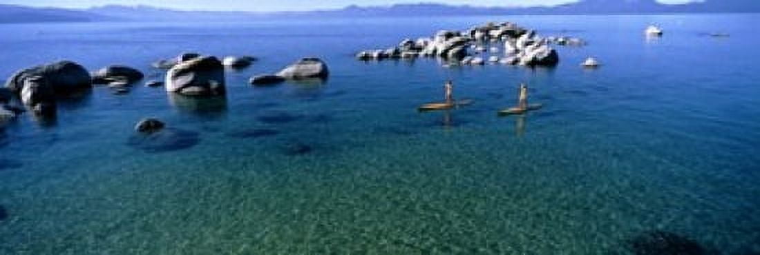 Two women paddle boarding in a lake Lake Tahoe California USA Canvas Art - Panoramic Images (18 x 6)