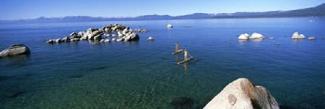 Two women paddle boarding in a lake Lake Tahoe California USA Canvas Art - Panoramic Images (18 x 6)