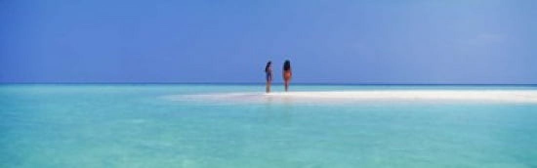 Two women standing on the beach sandbar Maayafushi Island Ari Atoll Maldives Canvas Art - Panoramic Images (18 x 6)