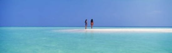 Two women standing on the beach sandbar Maayafushi Island Ari Atoll Maldives Canvas Art - Panoramic Images (36 x 12)