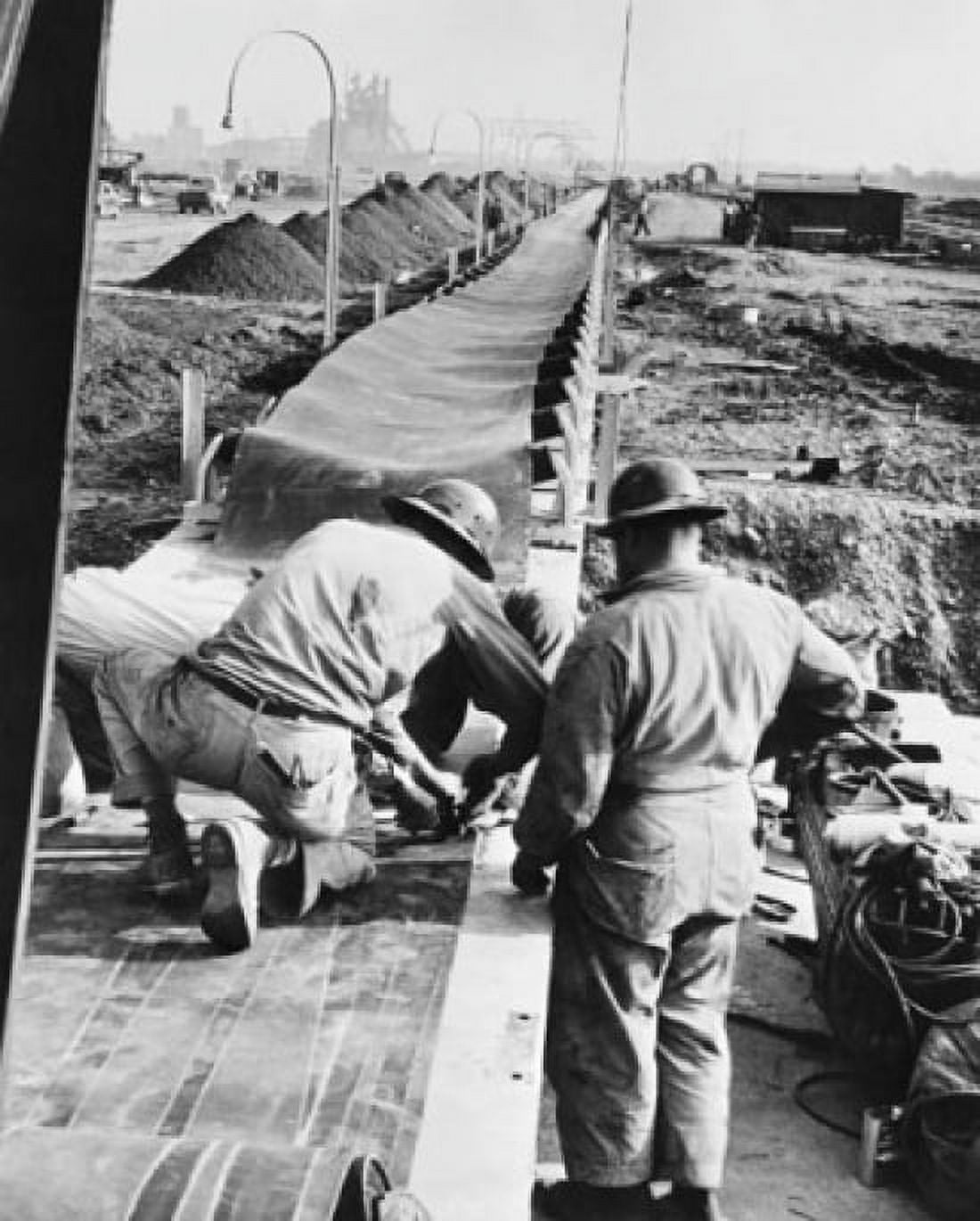Two workers laying a conveyor belt US Steel Canvas Art - (18 x 24)