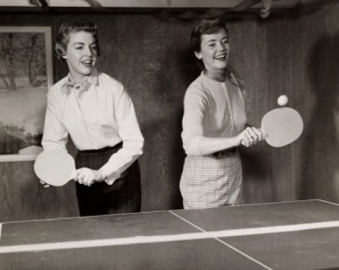 Two young adult women playing ping pong Canvas Art - (24 x 36)