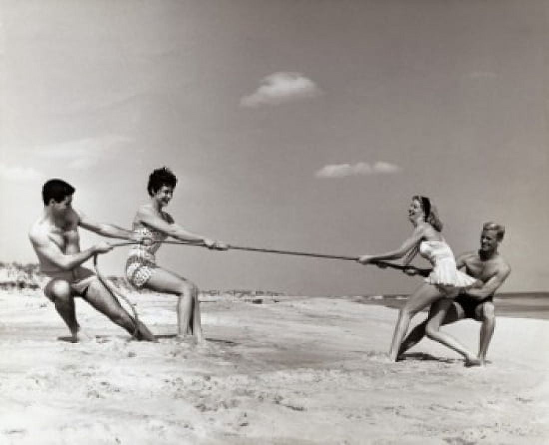 Two young couples playing tug-of-war on the beach Canvas Art - (24 x 36)