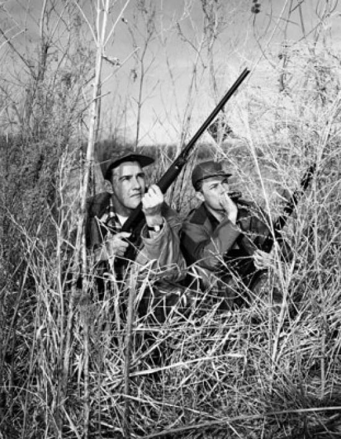Two young men holding guns and hunting Canvas Art - (24 x 36)